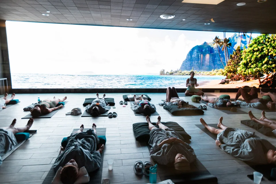 Coastal visuals behind a group relaxation session.