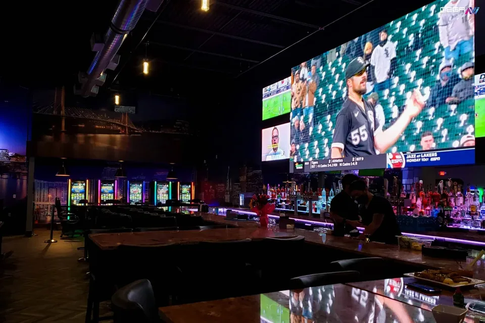 Large sports display above the bar at Cities Bar & Grill