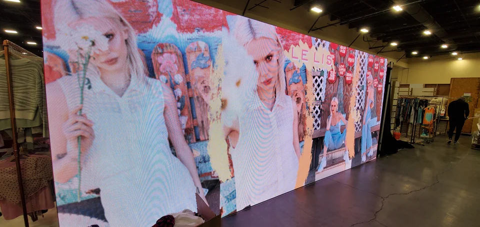 Campaign photography displayed along the booth wall.