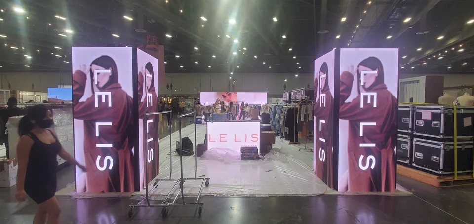 Multi-sided LED columns during booth preparation.
