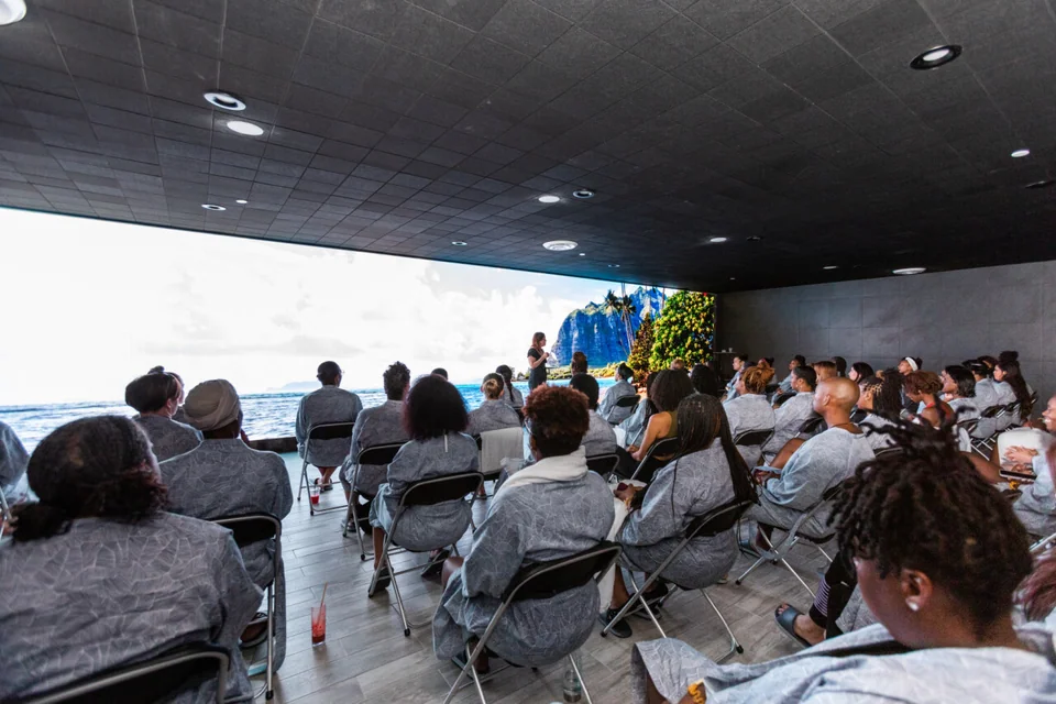 Seated group facing the wide display in the finished room.
