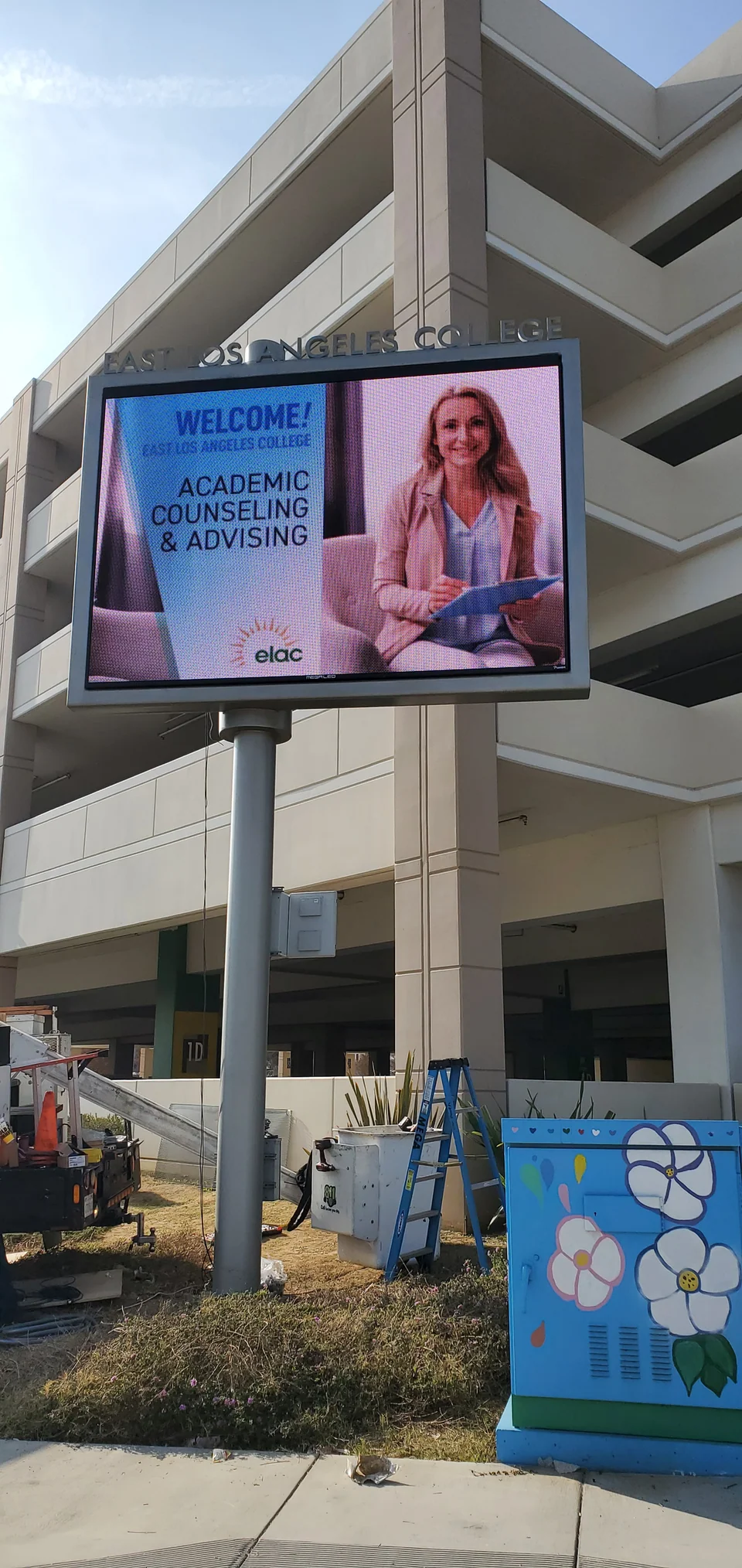 Pole-mounted campus display showing academic counseling information.
