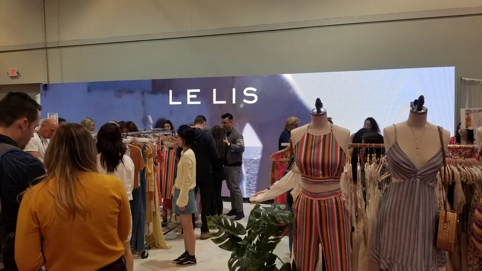The display behind clothing racks during the exhibition.