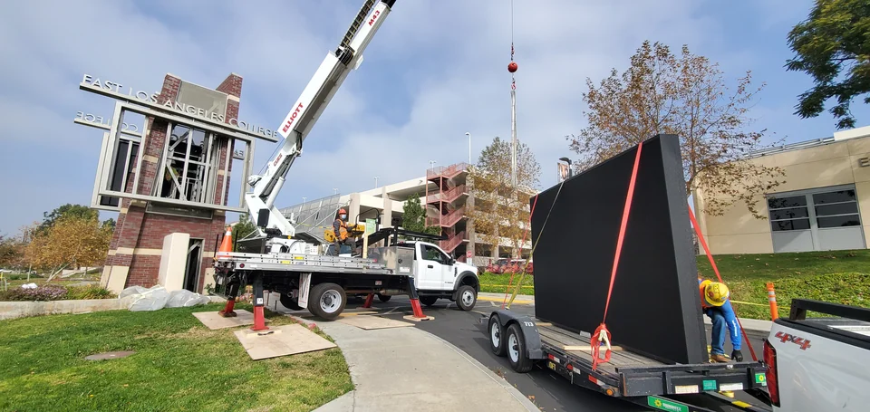 Display and lifting equipment beside the campus monument structure.