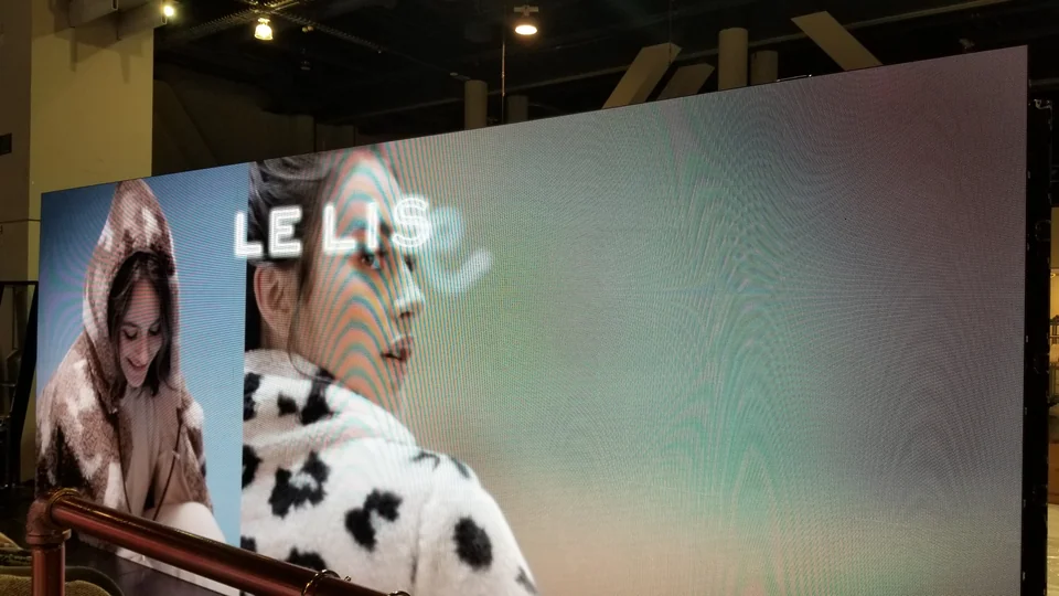 An angled close view of fashion content on the LED wall.